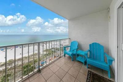 a balcony with two chairs and a view of the beach at The Summit 924 in Panama City Beach