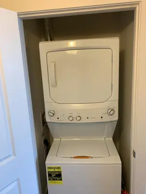 a white microwave sitting on top of a refrigerator at Sunset Cove at Calypso III in Panama City Beach