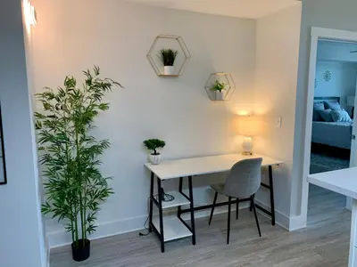 a dining room with a table and chairs and a plant at Sunset Cove at Calypso III in Panama City Beach
