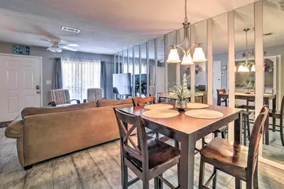 a living room with a table and a couch at Beautiful PCB Townhome Balcony and Resort Amenities in Panama City Beach