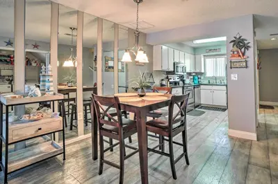 a kitchen and dining room with a table and chairs at Beautiful PCB Townhome Balcony and Resort Amenities in Panama City Beach