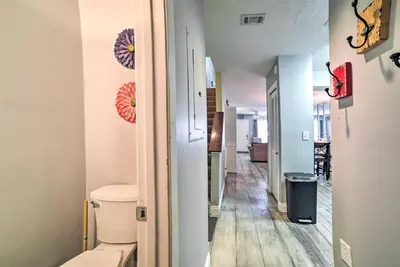 a bathroom with a toilet and a hallway at Beautiful PCB Townhome Balcony and Resort Amenities in Panama City Beach