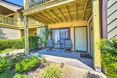 a porch of a house with a table and chairs at Beautiful PCB Townhome Balcony and Resort Amenities in Panama City Beach