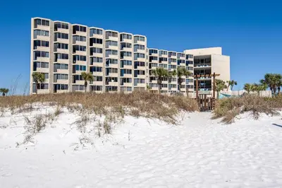 a large building on the beach with a sandy beach at Top of the Gulf 210 in Panama City Beach