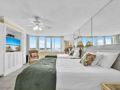 a bedroom with two beds and a ceiling fan at Top of the Gulf 610 in Panama City Beach