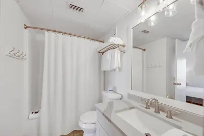 a white bathroom with a sink and a toilet at Edgewater Tower 2-805 in Panama City Beach