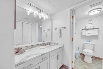 a white bathroom with a sink and a toilet at Edgewater Tower 2-805 in Panama City Beach