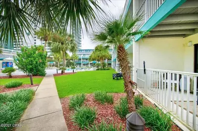 a palm tree on the side of a house at Nautical Watch E-4 in Panama City Beach