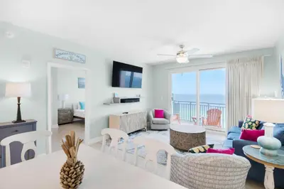 a living room with a view of the ocean at Sterling Breeze 1401 in Panama City Beach