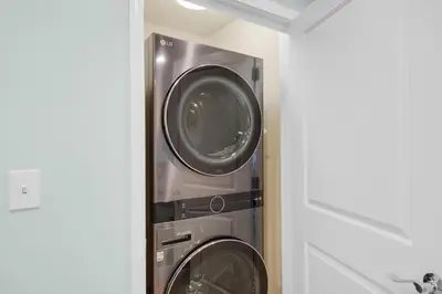 two washing machines are in a utility room at Sterling Breeze 1401 in Panama City Beach