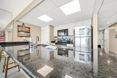 a kitchen with a counter top and a refrigerator at Edgewater Tower 2-1208 in Panama City Beach