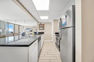 a kitchen with a stainless steel refrigerator at Edgewater Tower 2-1208 in Panama City Beach