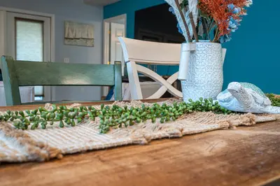 a table with a bunch of green plants on it at PALM COVE VACATION HOME- One level, Community pool, Pet Friendly in Panama City Beach