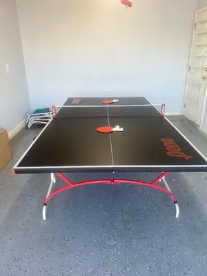 a ping pong table in a room at PALM COVE VACATION HOME- One level, Community pool, Pet Friendly in Panama City Beach
