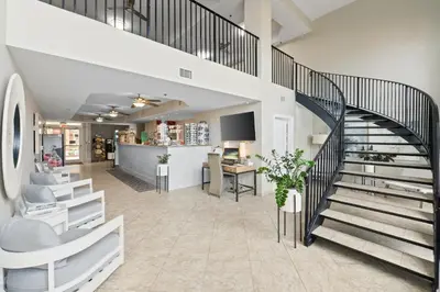 a spiral staircase in a office with a desk at Calypso Beach Resort & Towers by Panhandle Getaways in Panama City Beach