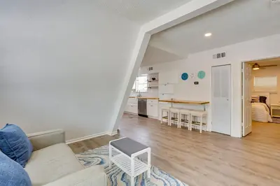 a living room with a couch and a kitchen at Cozy 3BRand3BA • Sleeps 9 • 0 3 Mi to Beach • PCB in Panama City Beach