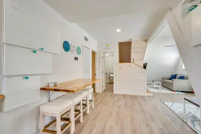 a kitchen and dining room with a table and chairs at Cozy 3BRand3BA • Sleeps 9 • 0 3 Mi to Beach • PCB in Panama City Beach