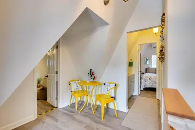 a dining room with a table and two yellow chairs at Cozy 3BRand3BA • Sleeps 9 • 0 3 Mi to Beach • PCB in Panama City Beach