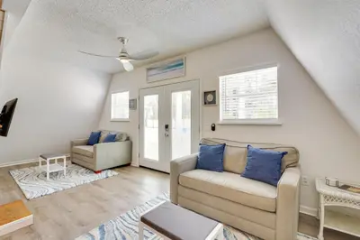 a living room with a couch and a chair at Cozy 3BRand3BA • Sleeps 9 • 0 3 Mi to Beach • PCB in Panama City Beach
