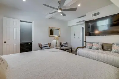 a bedroom with two beds and a ceiling fan at Cozy 3BRand3BA • Sleeps 9 • 0 3 Mi to Beach • PCB in Panama City Beach