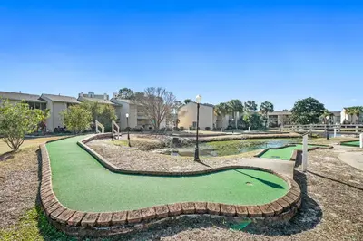 a golf course with a putting green at Gulf Highland Rentals by Panhandle Getaways in Panama City Beach