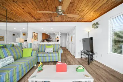 a living room with a couch and a table at Seaward Townhome Rentals by Panhandle Getaways in Panama City Beach