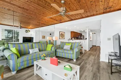 a living room with two couches and a table at Seaward Townhome Rentals by Panhandle Getaways in Panama City Beach