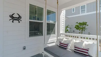 a porch with two pillows and a window at Crab Cottage in Inlet Beach
