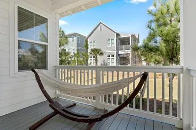 a hammock on the front porch of a house at Crab Cottage in Inlet Beach