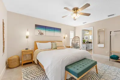 a bedroom with a bed and a ceiling fan at Beach bliss awaits! - Beach, Pools, Tiki-Deck, Arcade, Putting green, Family Fun! in Panama City Beach