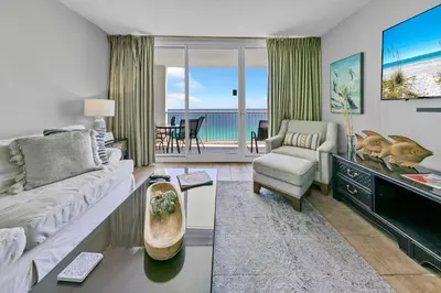a living room with a couch and a table at Majestic Beach Towers I 2002 Stay Salty in Panama City Beach