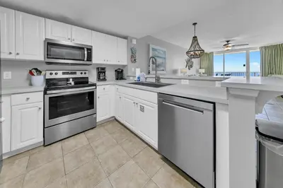 a kitchen with white cabinets and white appliances at Majestic Beach Towers I 2002 Stay Salty in Panama City Beach