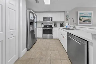 a kitchen with white cabinets and stainless steel appliances at Majestic Beach Towers I 2002 Stay Salty in Panama City Beach