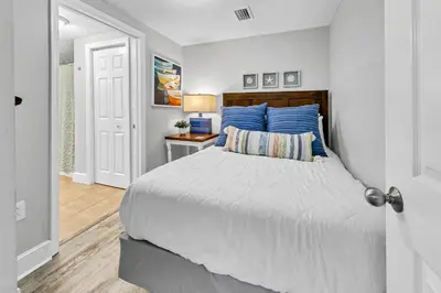 a bedroom with a bed and a table with a lamp at Majestic Beach Towers I 2002 Stay Salty in Panama City Beach