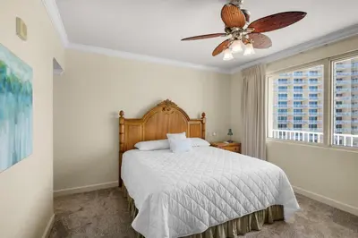 a bedroom with a bed and a ceiling fan at Shores of Panama 1313 in Panama City Beach