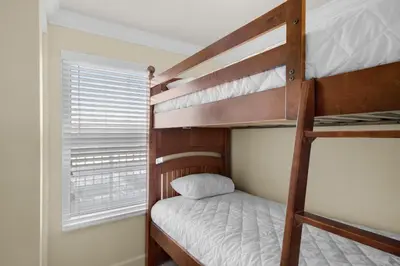 a bedroom with two bunk beds and a window at Shores of Panama 1313 in Panama City Beach