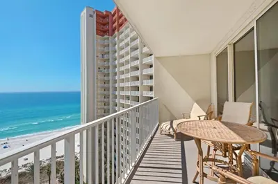 a balcony with a table and chairs and the beach at Shores of Panama 1313 in Panama City Beach