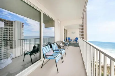 a balcony with chairs and a view of the ocean at Shores of Panama 1523 in Panama City Beach