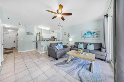 a living room with a couch and a table at Shores of Panama 1523 in Panama City Beach