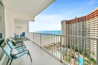 a balcony with chairs and a view of the ocean at Shores of Panama 1523 in Panama City Beach