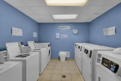 a blue room with washing machines and a toilet at Sunbird 412E in Panama City Beach