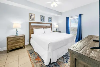 a bedroom with a white bed and a window at Majestic Beach Towers 1-1907 in Panama City Beach