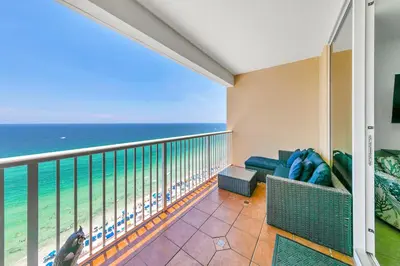 a balcony with a couch and the ocean at Majestic Beach Towers 1-1907 in Panama City Beach