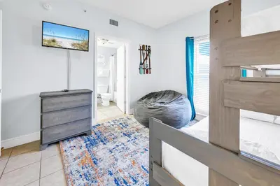 a bedroom with a bunk bed and a bedroom with a dresser at Majestic Beach Towers 1-1907 in Panama City Beach
