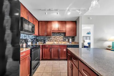 a kitchen with wooden cabinets and a counter top at Laketown Wharf 1627 in Panama City Beach