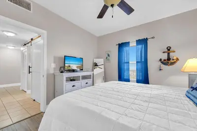 a bedroom with a large bed and a tv at Laketown Wharf 1627 in Panama City Beach