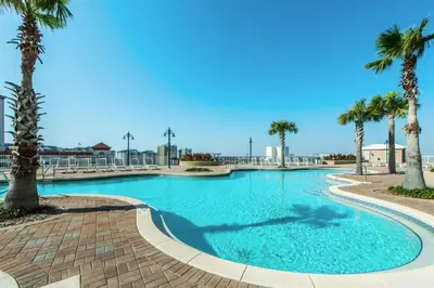 a swimming pool with palm trees in a resort at Laketown Wharf 1627 in Panama City Beach