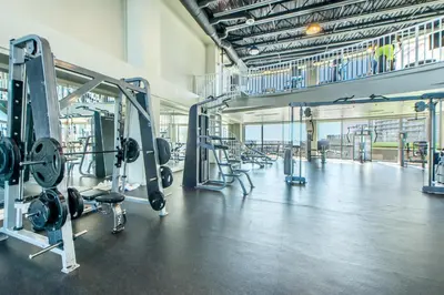 a gym with rows of equipment in a large room at Laketown Wharf 1627 in Panama City Beach