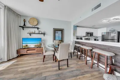 a kitchen and dining room with a table and chairs at Majestic Beach Towers 1-1911 in Panama City Beach