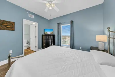 a bedroom with a large white bed and a window at Majestic Beach Towers 1-1911 in Panama City Beach